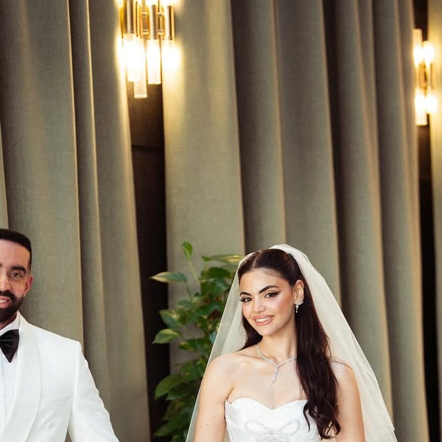 A beaded ivory bridal gown photographed in soft daylight.